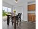 Cozy dining area with table set near a slider door and kitchen, featuring luxury vinyl flooring and natural light at 597 Skyridge Rd, Clermont, FL 34711