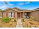 Inviting front entrance with colorful landscaping, accent plants, and decorative chairs, adding curb appeal at 597 Skyridge Rd, Clermont, FL 34711