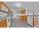Well lit kitchen features wood cabinets, stainless steel refrigerator, and modern appliances at 597 Skyridge Rd, Clermont, FL 34711