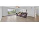 Open-concept living room with luxury vinyl flooring, large windows, a comfortable seating area, and scenic views at 597 Skyridge Rd, Clermont, FL 34711
