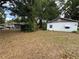 The exterior of a weathered single-story home has a small yard with leaves and shade trees at 600 Powell St, Wildwood, FL 34785
