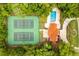 Aerial view of the community tennis courts nestled amongst lush greenery, providing a private recreational space at 657 Riverpark Cir, Longwood, FL 32779