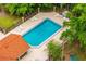 Aerial view of a community pool with lounge chairs and an American flag in a lush green environment at 657 Riverpark Cir, Longwood, FL 32779