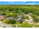 An aerial view highlights the home and its location in a neighborhood with mature landscaping at 657 Riverpark Cir, Longwood, FL 32779
