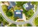 An aerial view shows a home with a pool in a suburban neighborhood with well manicured landscaping at 657 Riverpark Cir, Longwood, FL 32779