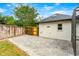 Private backyard featuring a paved patio area, perfect for outdoor seating and relaxation next to the detached garage at 657 Riverpark Cir, Longwood, FL 32779