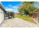 Lush backyard with a paved patio area, showcasing an in-ground fire pit and views of the screened-in pool area at 657 Riverpark Cir, Longwood, FL 32779