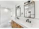 A stylish bathroom with double sinks, quartz countertop, decorative light fixtures and tiled walk-in shower at 657 Riverpark Cir, Longwood, FL 32779