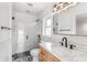 Modern bathroom featuring a glass-enclosed shower and a stylish vanity with marble countertop and contemporary fixtures at 657 Riverpark Cir, Longwood, FL 32779