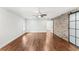 Spacious bedroom with hardwood floors, ceiling fan, brick accent wall, and sliding barn door at 657 Riverpark Cir, Longwood, FL 32779