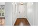Bright foyer with hardwood floors, white walls, and stylish light fixture at 657 Riverpark Cir, Longwood, FL 32779