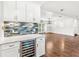 Bright kitchen featuring white cabinets, quartz countertops and a wine cooler, creating a modern and elegant space at 657 Riverpark Cir, Longwood, FL 32779