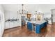 Spacious kitchen with stainless steel appliances, large island, beverage cooler, and modern backsplash at 657 Riverpark Cir, Longwood, FL 32779