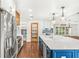 Bright kitchen with large center island, stainless steel appliances and wood accents at 657 Riverpark Cir, Longwood, FL 32779