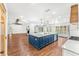 Open kitchen with a blue center island, quartz countertops and stainless steel appliances in a spacious design at 657 Riverpark Cir, Longwood, FL 32779