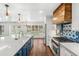 Well-lit kitchen with a large island, stainless steel appliances, custom backsplash and hardwood floors at 657 Riverpark Cir, Longwood, FL 32779