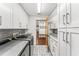 Well-organized laundry room with white cabinets, granite countertops, modern washer/dryer, and stylish tile flooring at 657 Riverpark Cir, Longwood, FL 32779