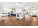 Open concept living room with hardwood floors, fireplace, recessed lighting, and kitchen in background at 657 Riverpark Cir, Longwood, FL 32779