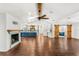 Spacious living room with hardwood floors, fireplace, ceiling fan, and sliding barn doors at 657 Riverpark Cir, Longwood, FL 32779