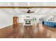 Open concept living room with hardwood floors, fireplace, and large kitchen island at 657 Riverpark Cir, Longwood, FL 32779