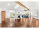 Bright, open concept living room with hardwood floors, fireplace and kitchen with a large island at 657 Riverpark Cir, Longwood, FL 32779