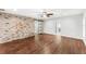 Spacious main bedroom with exposed brick wall, wood flooring, and sliding barn door to the closet at 657 Riverpark Cir, Longwood, FL 32779