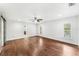 Bright main bedroom with wood floors, modern ceiling fan, large windows, and neutral color palette at 657 Riverpark Cir, Longwood, FL 32779