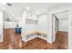 Functional mudroom with built-in bench, storage cubbies, shiplap walls and wood flooring at 657 Riverpark Cir, Longwood, FL 32779