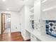 Bright home office featuring built-in shelves, white cabinets, a desk area and modern finishes at 657 Riverpark Cir, Longwood, FL 32779