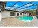 Sparkling pool within a screened enclosure, surrounded by a paved patio and lush landscaping, perfect for relaxation and recreation at 657 Riverpark Cir, Longwood, FL 32779