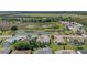 Expansive aerial perspective showing a neighborhood next to a tranquil water feature and green fields at 6608 Borg, Leesburg, FL 34748