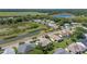 Wide aerial view showing a neighborhood alongside a winding waterway and vast green spaces at 6608 Borg, Leesburg, FL 34748
