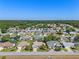 Wide aerial view of a sprawling residential area with houses, trees, and landscaping at 6608 Borg, Leesburg, FL 34748