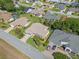 Birds eye view of a home and surrounding neighborhood with lush green lawns and mature trees at 6608 Borg, Leesburg, FL 34748