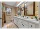 Elegant bathroom boasting a double vanity, decorative mirrors, and modern fixtures and a neutral color palette at 6608 Borg, Leesburg, FL 34748