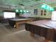 Enjoy games of billiards in this well-lit billiards room featuring multiple tables and vintage pendant lighting at 6608 Borg, Leesburg, FL 34748