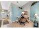 Bright dining area with light blue walls, modern lighting fixture, and a round glass table at 6608 Borg, Leesburg, FL 34748