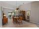Open dining room with a high ceiling, wooden table, chandelier lighting, and access to a screened porch at 6608 Borg, Leesburg, FL 34748