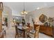 Inviting dining room with a wooden table, chandelier lighting, and views into the living room and kitchen at 6608 Borg, Leesburg, FL 34748