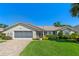 Charming single-story home featuring a well-manicured lawn, two-car garage, and neatly trimmed landscaping at 6608 Borg, Leesburg, FL 34748
