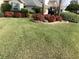 Beautiful front yard with flower beds and a lush green lawn, enhancing the home's curb appeal at 6608 Borg, Leesburg, FL 34748