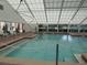 Bright indoor pool with clear water, multiple access points, and a large skylight at 6608 Borg, Leesburg, FL 34748