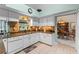 Efficient kitchen layout with white cabinets, granite countertops, tiled backsplash, and modern appliances at 6608 Borg, Leesburg, FL 34748