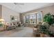 Bright living room with neutral walls, a large bay window, and comfortable seating, creating a cozy atmosphere at 6608 Borg, Leesburg, FL 34748