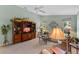 Inviting living room featuring a ceiling fan, neutral carpet, and large entertainment center at 6608 Borg, Leesburg, FL 34748