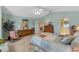 Spacious main bedroom with light blue walls, ceiling fan, and ensuite bathroom access at 6608 Borg, Leesburg, FL 34748