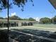 Play shuffleboard on this outdoor court lined with numbered sections, set against a backdrop of lush trees at 6608 Borg, Leesburg, FL 34748