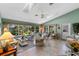 Bright sunroom with wicker furniture, large windows with view of the garden, and natural light at 6608 Borg, Leesburg, FL 34748