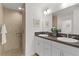 Bathroom featuring double sinks, vanity with abundant cabinet space, and walk-in shower at 7382 Se 167Th Zina Ln, The Villages, FL 32162