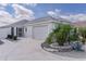 Charming one-story home featuring a two-car garage and well-manicured landscaping at 7382 Se 167Th Zina Ln, The Villages, FL 32162